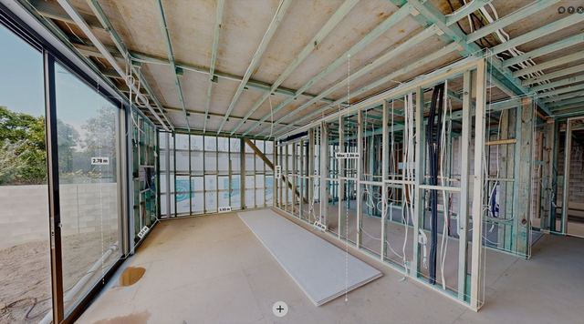 A framed living room with rough-ins before plasterboard